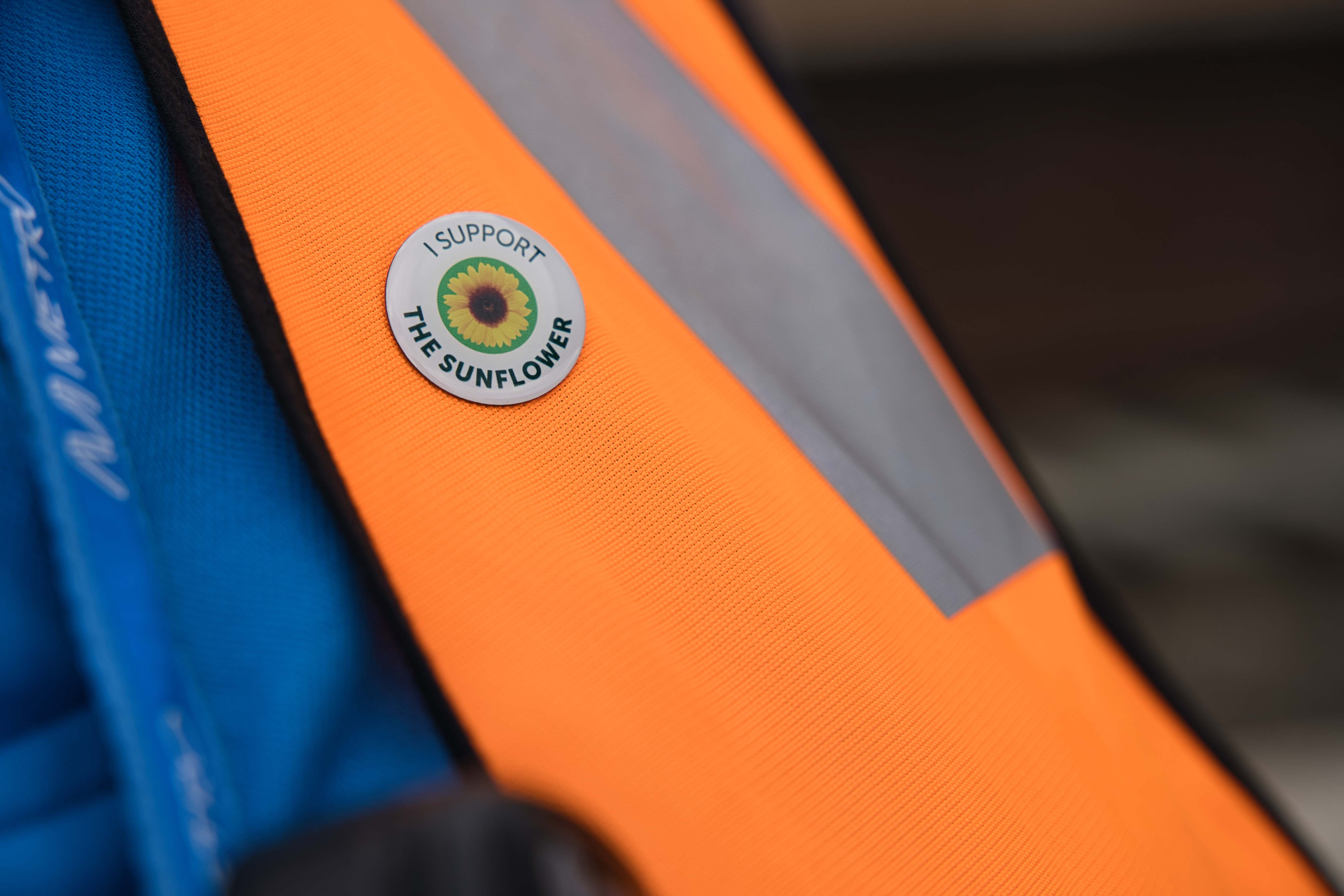 A Metro staff member wearing a Sunflower supporter badge